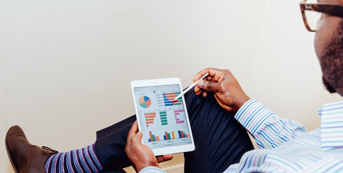 a man holding an ipad