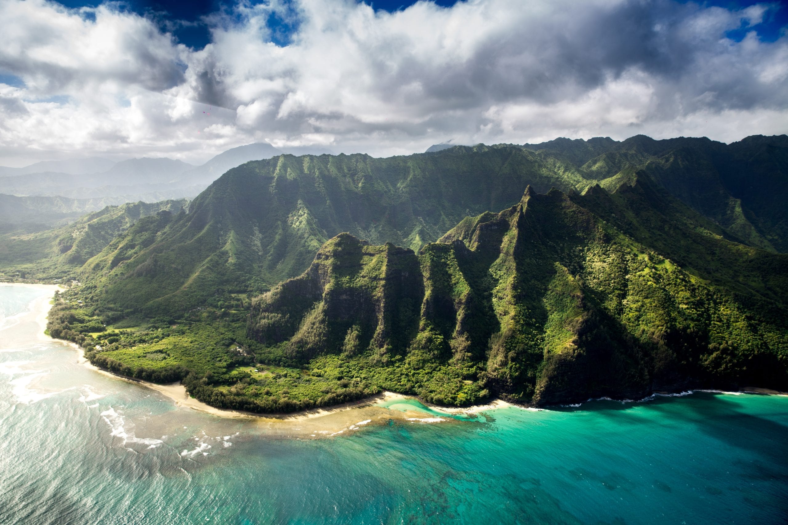na pali coast in kauai from the air with clear aqua water