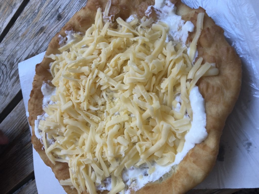 Traditional Langos fried bread topped with cheese