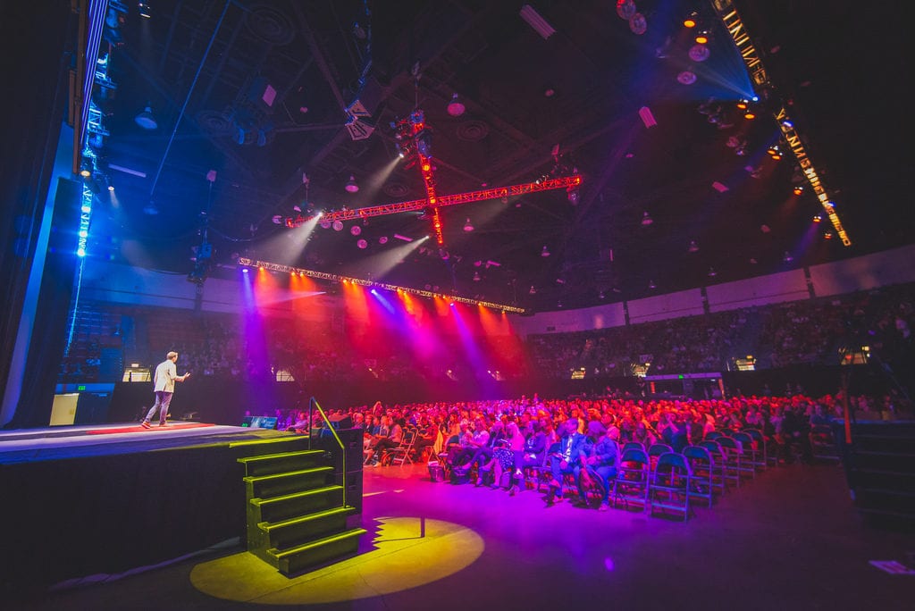 a man standing on stage in front of an audience