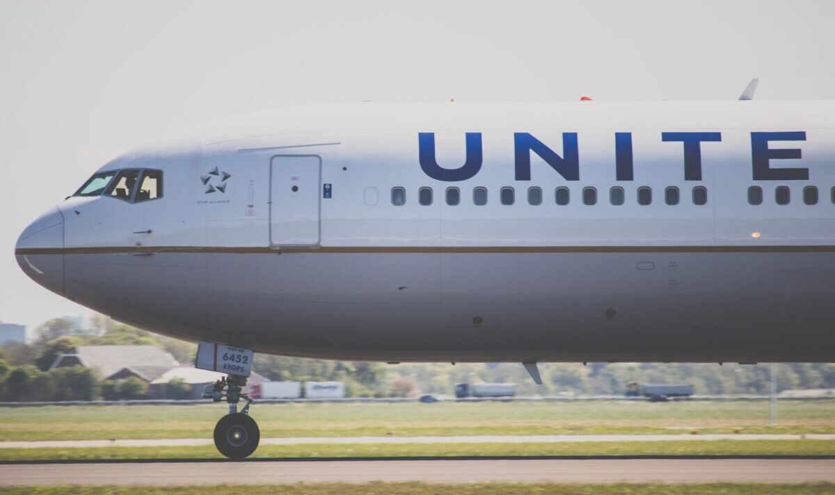 A united Airlines plane taxis down a runway.