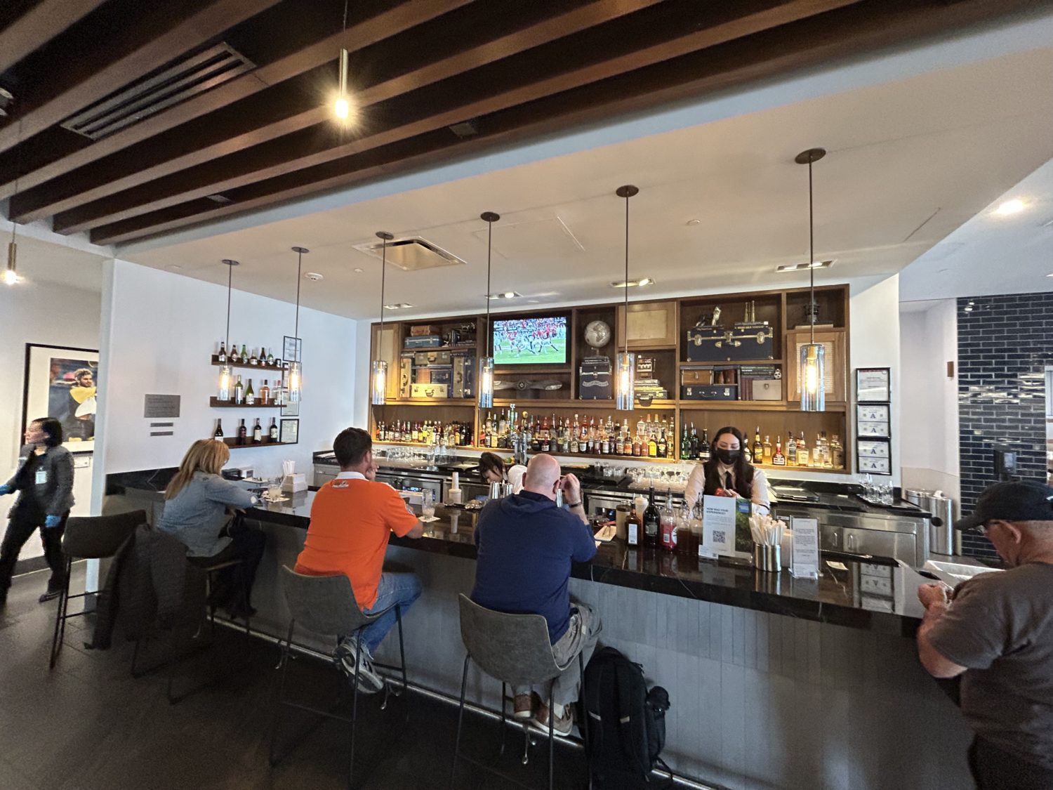 a bar with customers at an airport lounge
