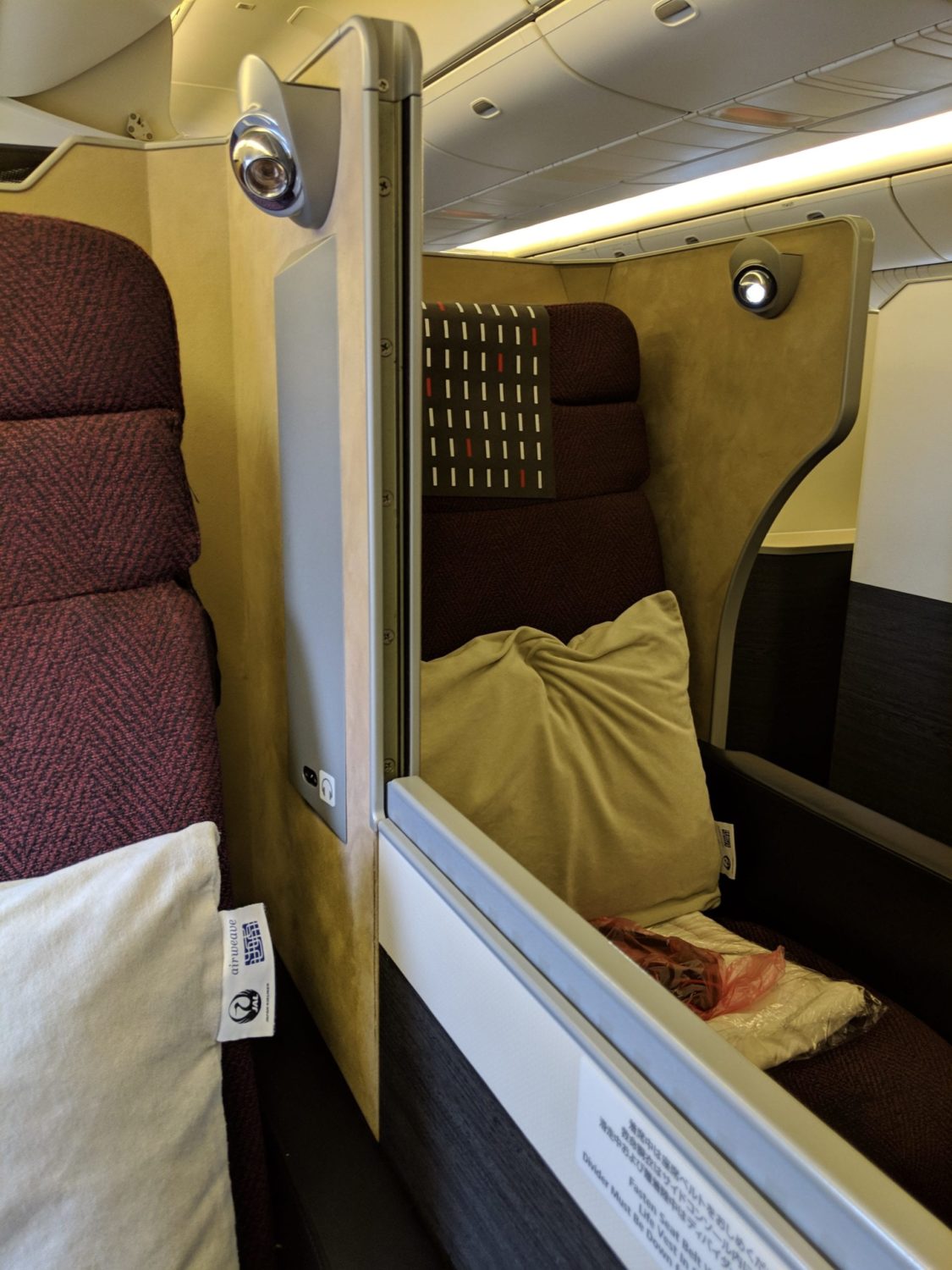 two business class seats separated by a low divider