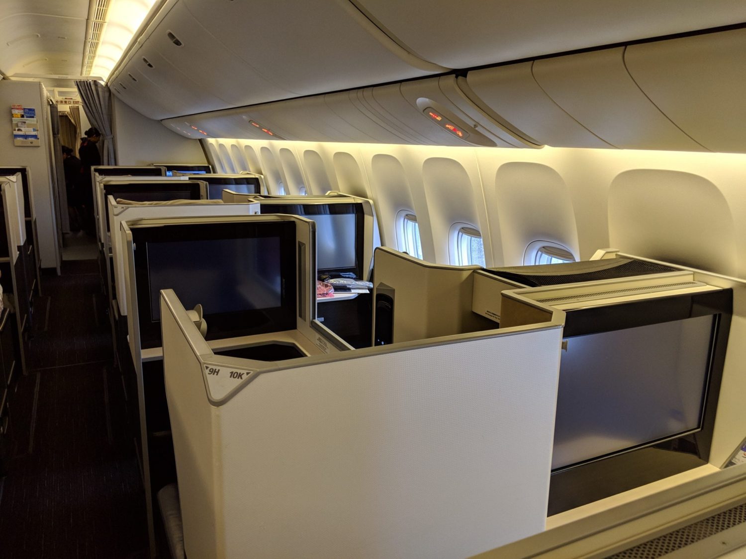 several rows of business class suites with large monitors