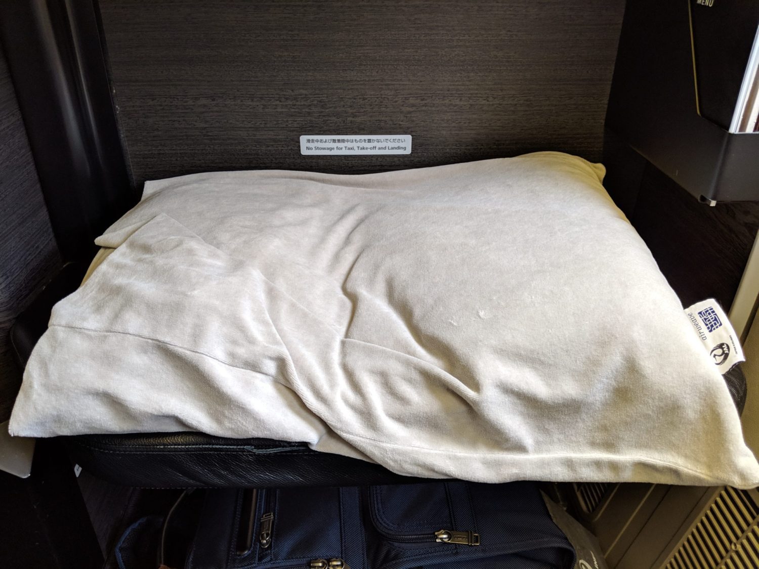 a pillow covered in a cream colored cloth case