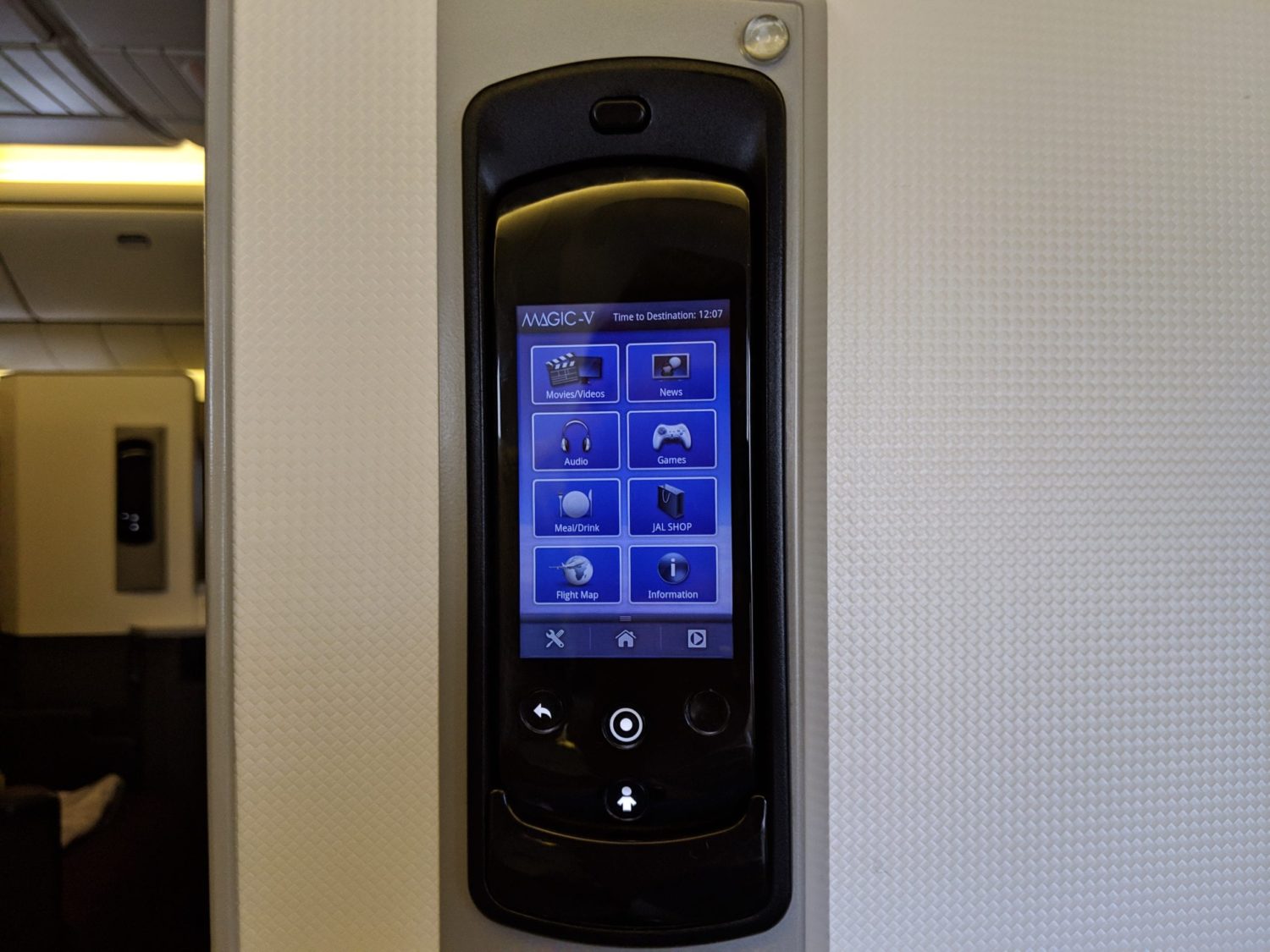 a black remote mounted inside of a business class seat