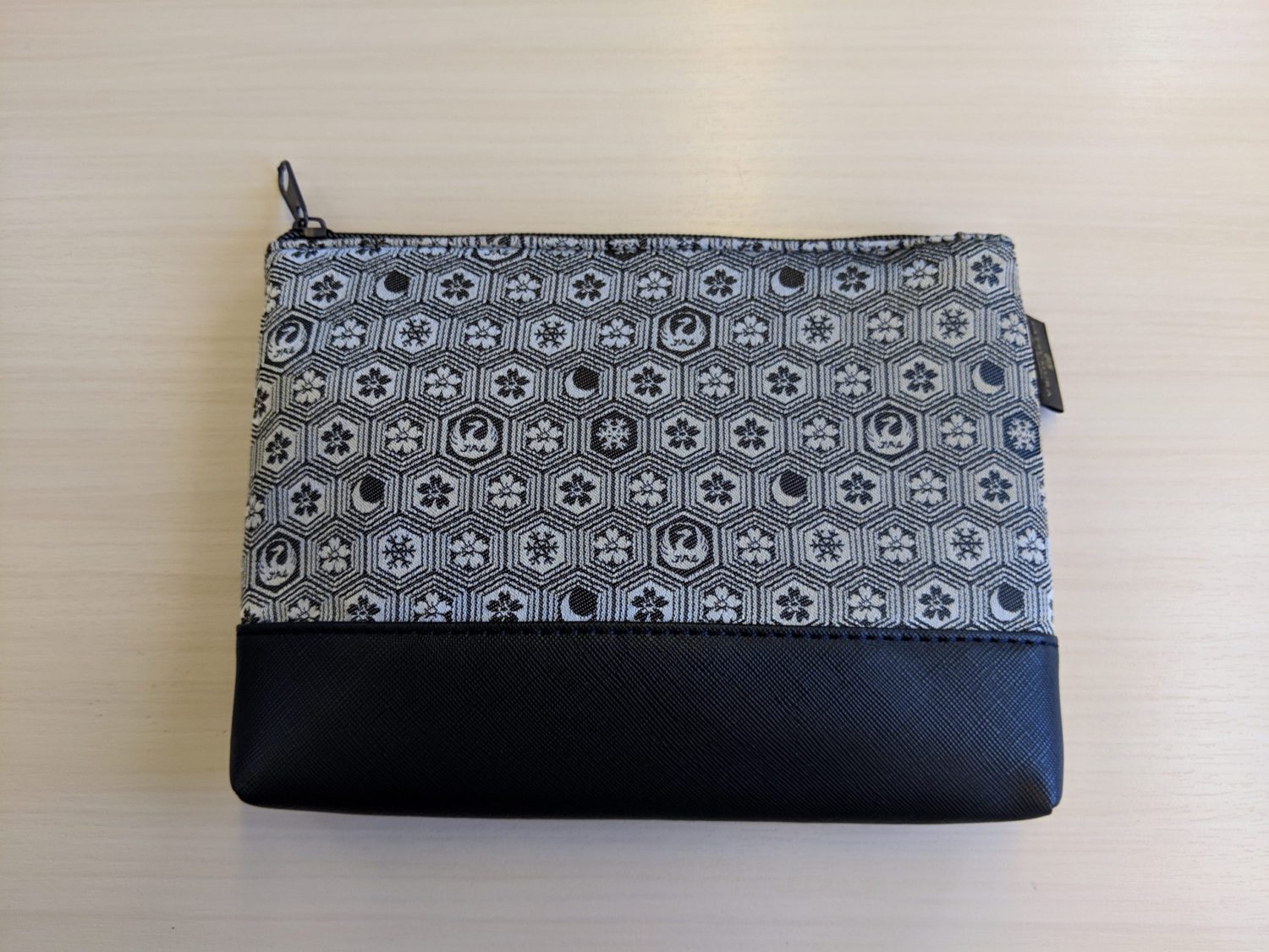 a small leather pouch with black and gray pattern