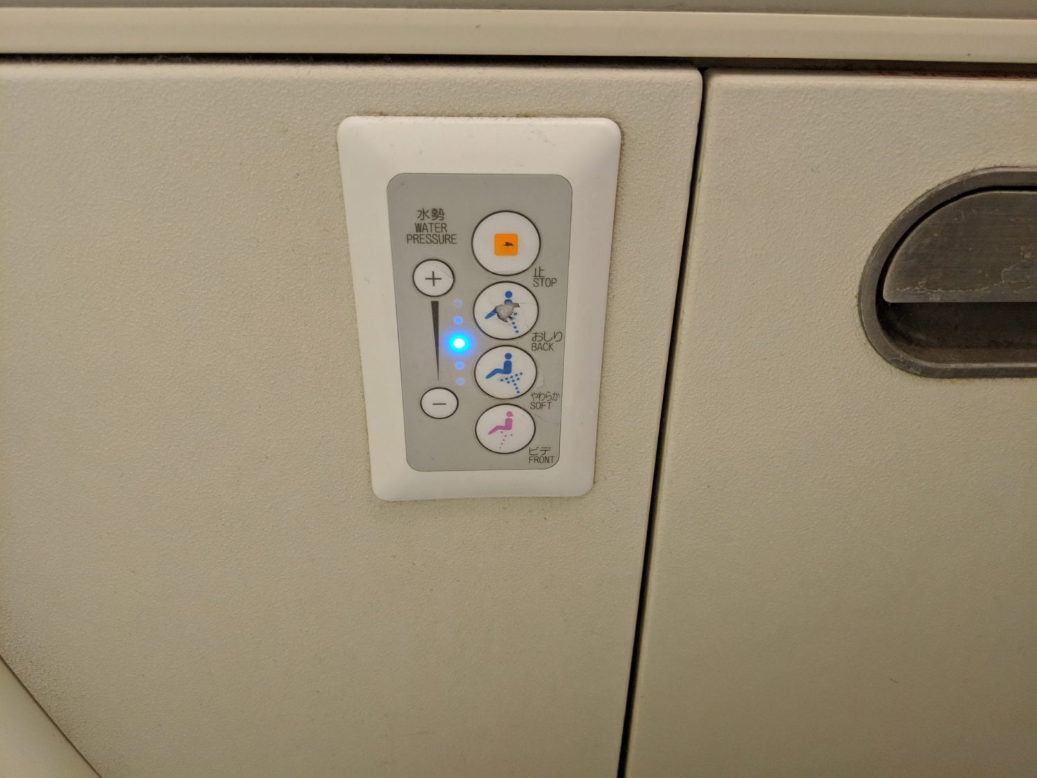 bidet function inside an airplane lavatory with buttons