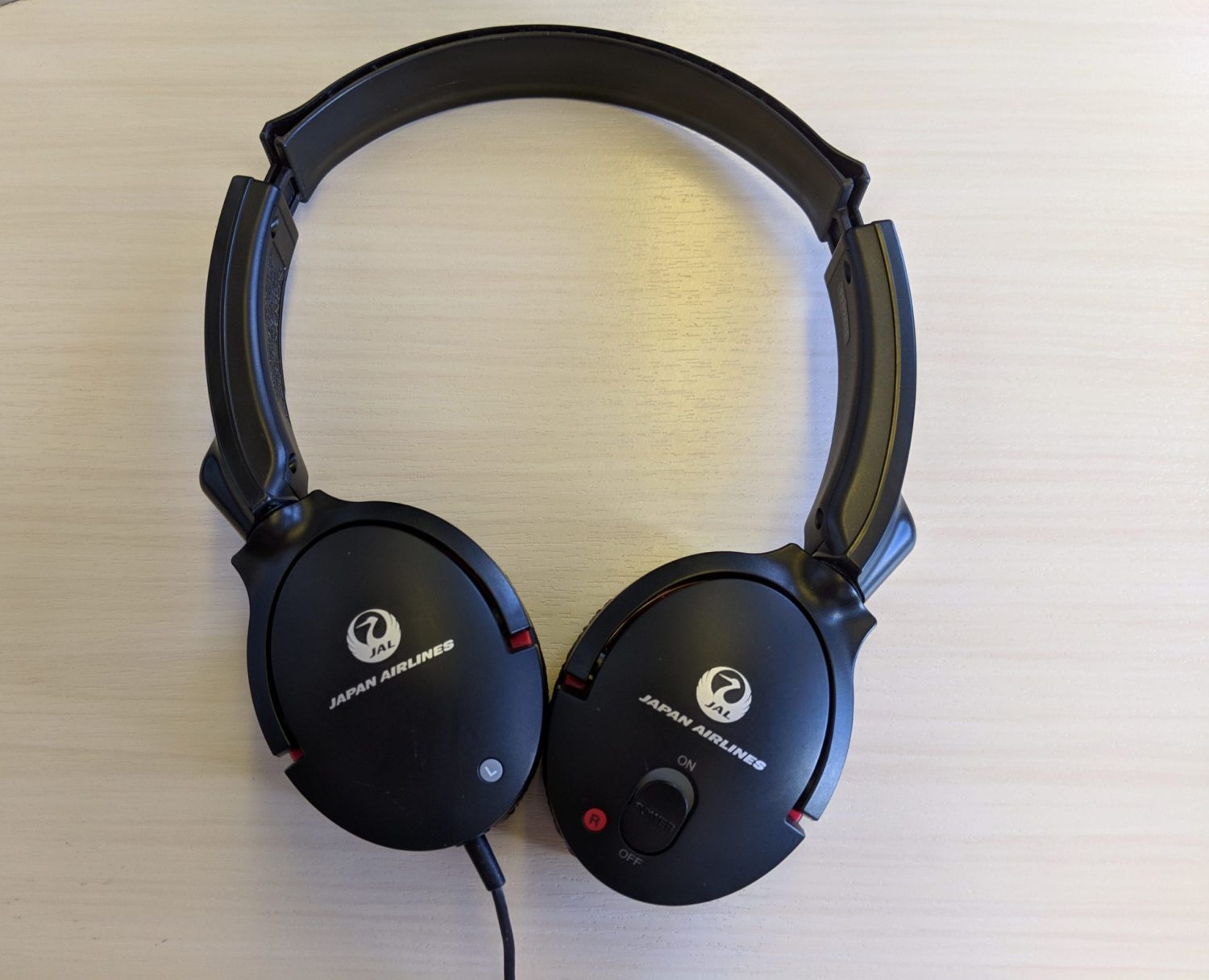 a pair of headphones branded with Japan Airlines' logo