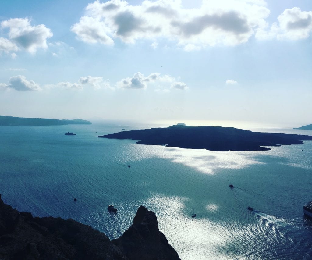 A group of clouds in the sky over a body of water