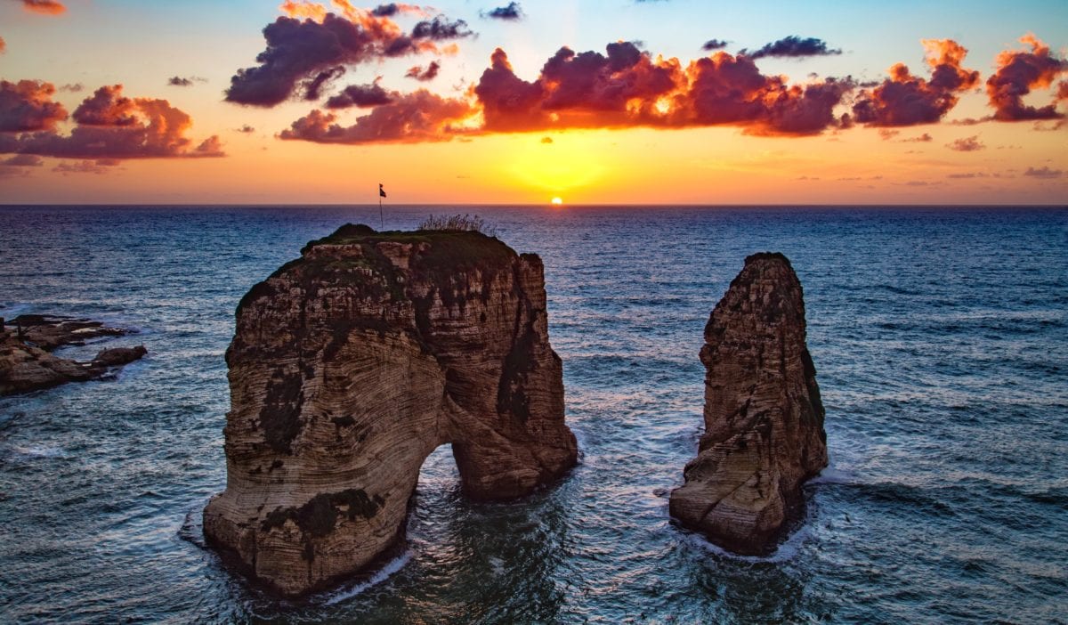 A close up of a large rock next to a body of water