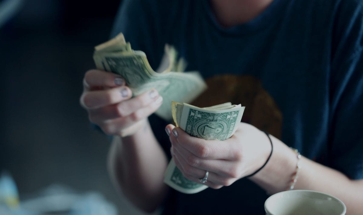 a person holding cash