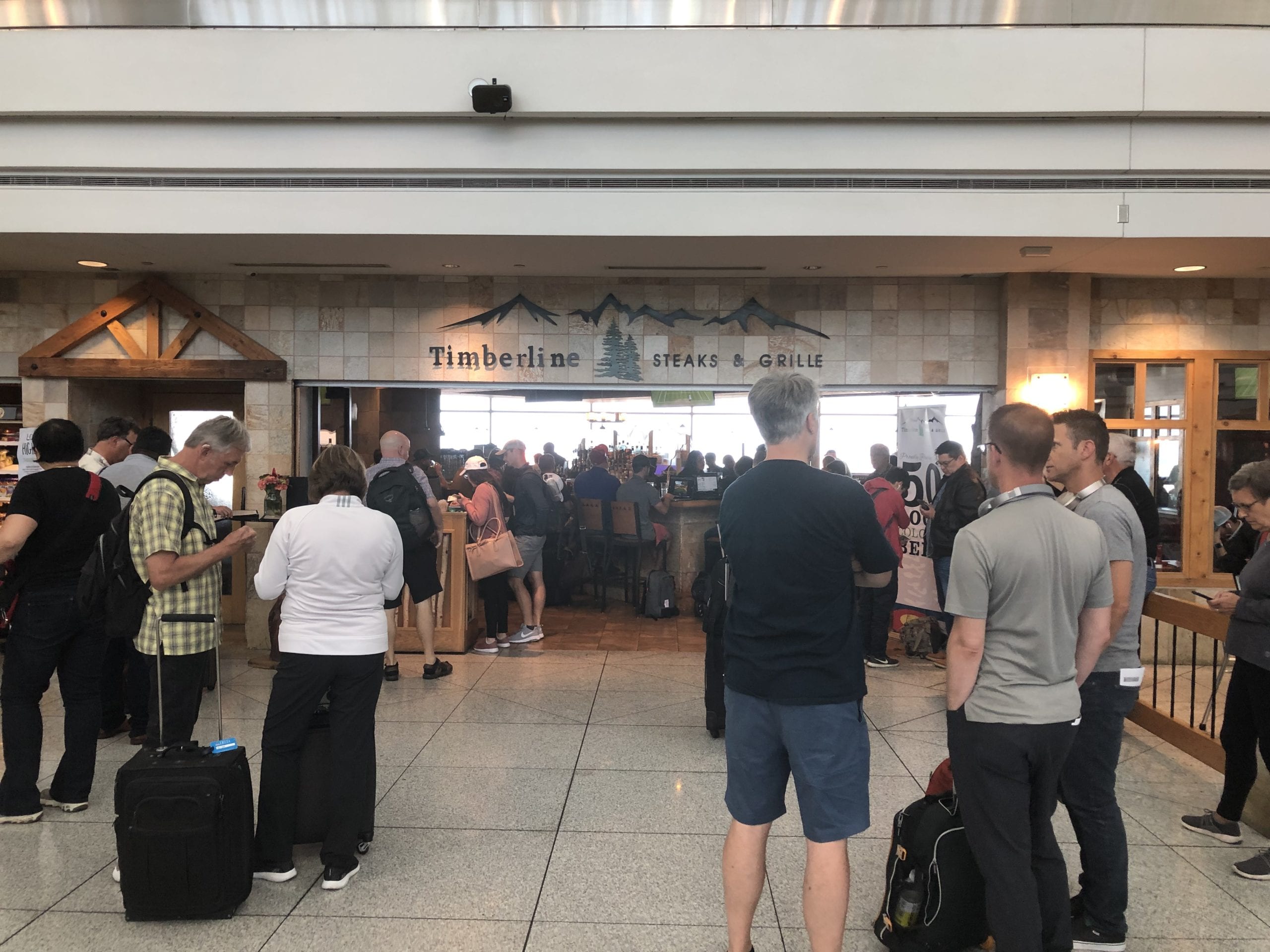 A group of people standing around an airport