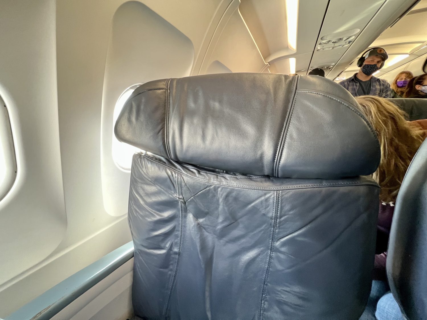 headrests on a large leather airplane seat