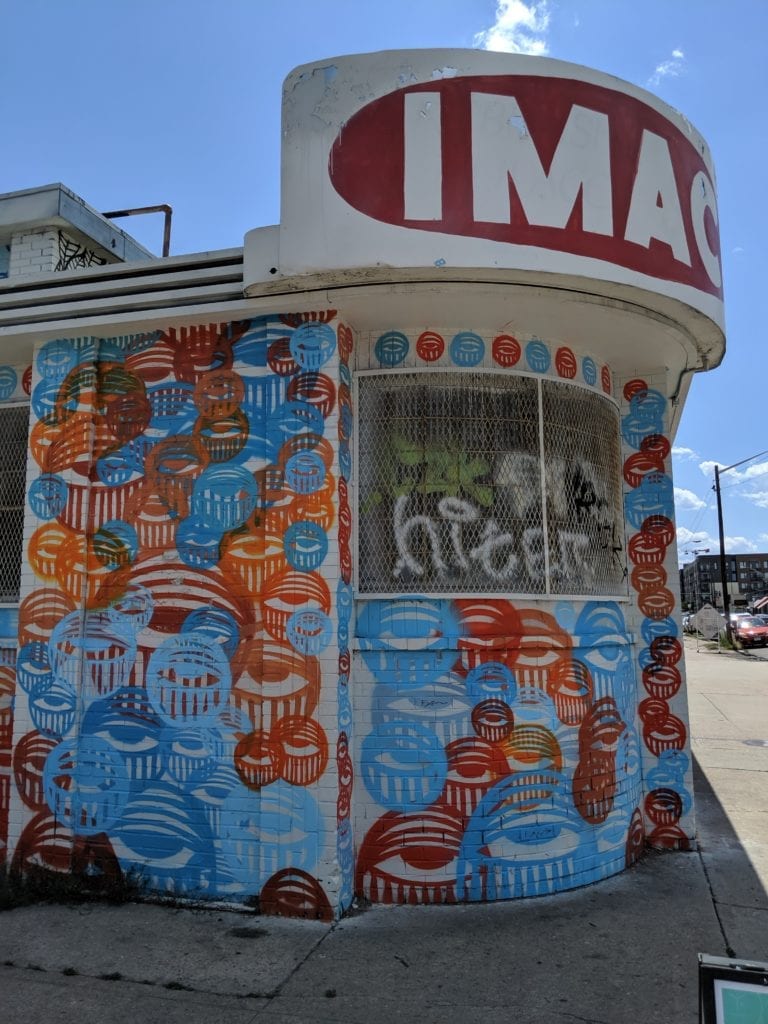 A lot of graffiti on the side of a building