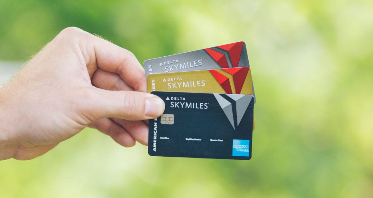 How to Book Round-Trip Flights to Europe for 30K SkyMiles 9 a man holding 3 delta credit cards