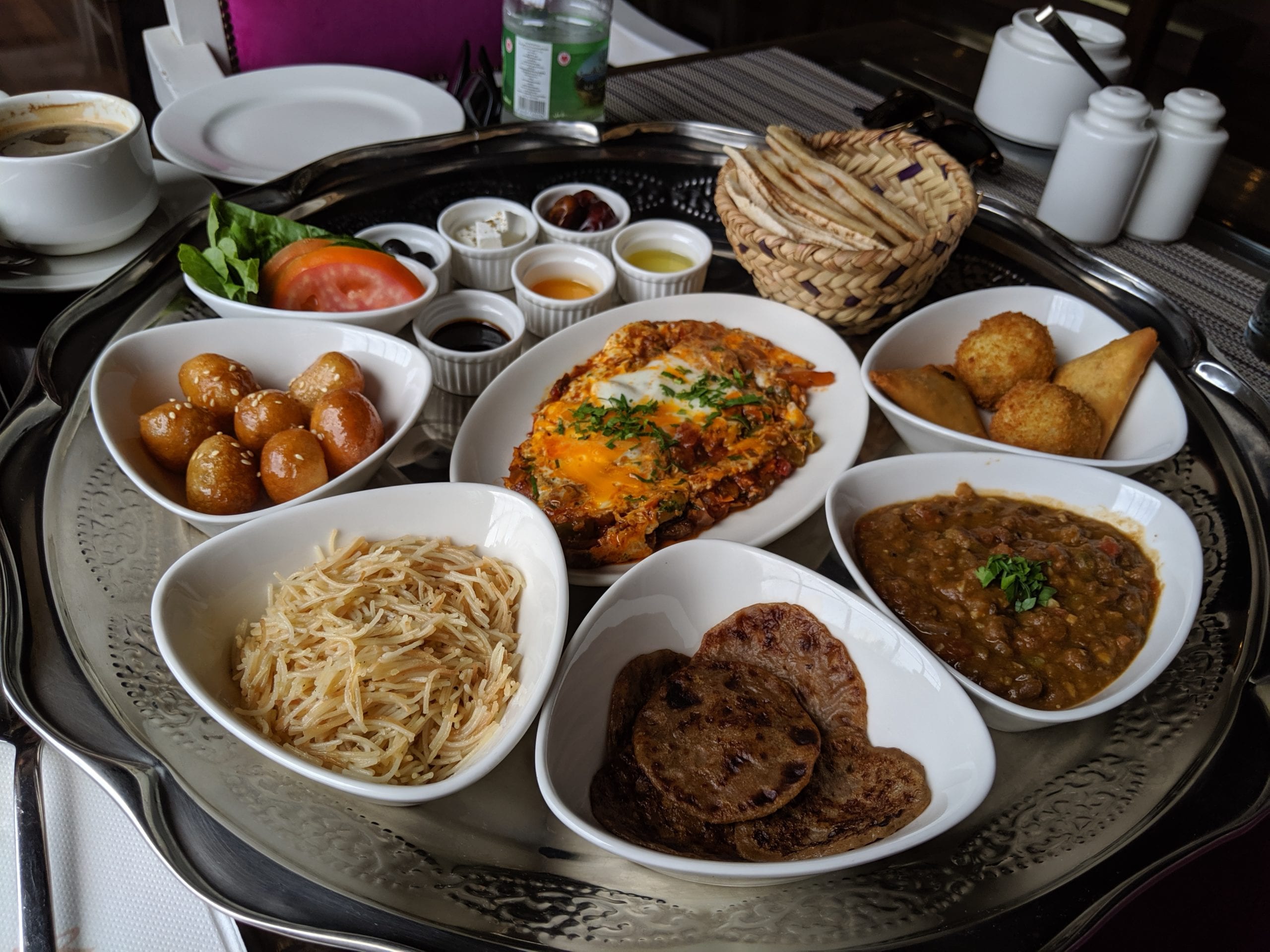 A bowl filled with different types of food on a table in Oman
