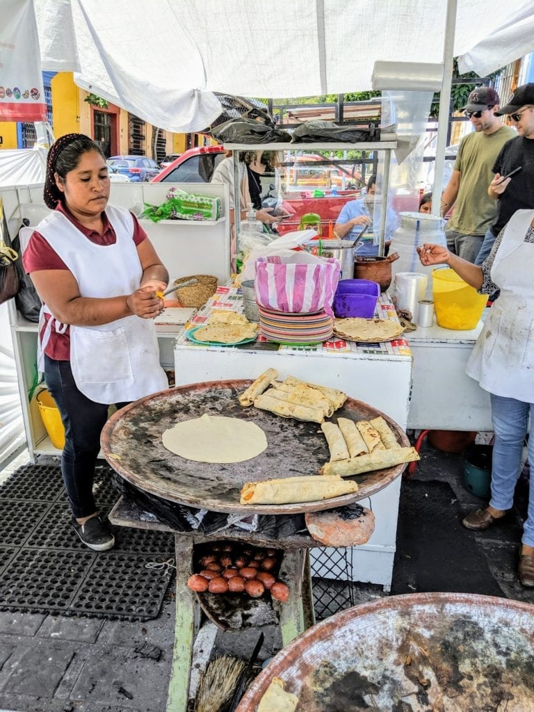Don't Miss Oaxaca, Mexico's Up-and-Coming Hot Spot 16 A man and a woman standing in front of a plate of food