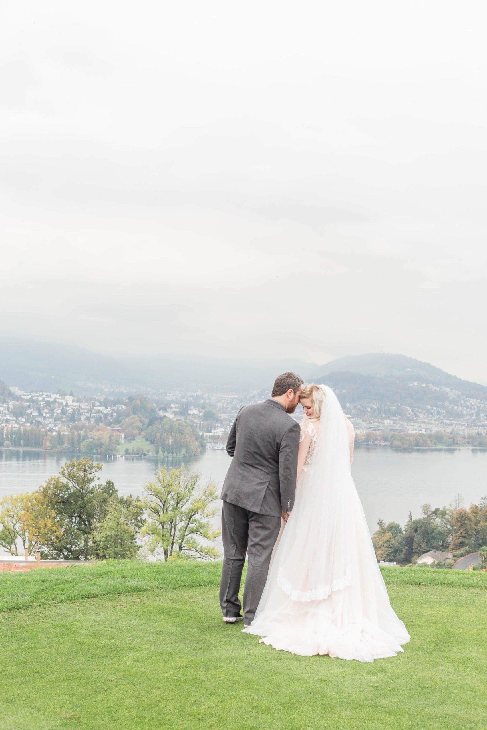 A man and woman standing on top of a grass covered field