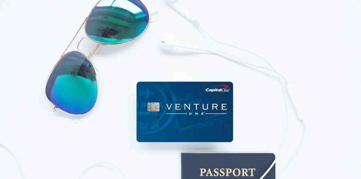 capital one ventureone card with a passport and sunglasses