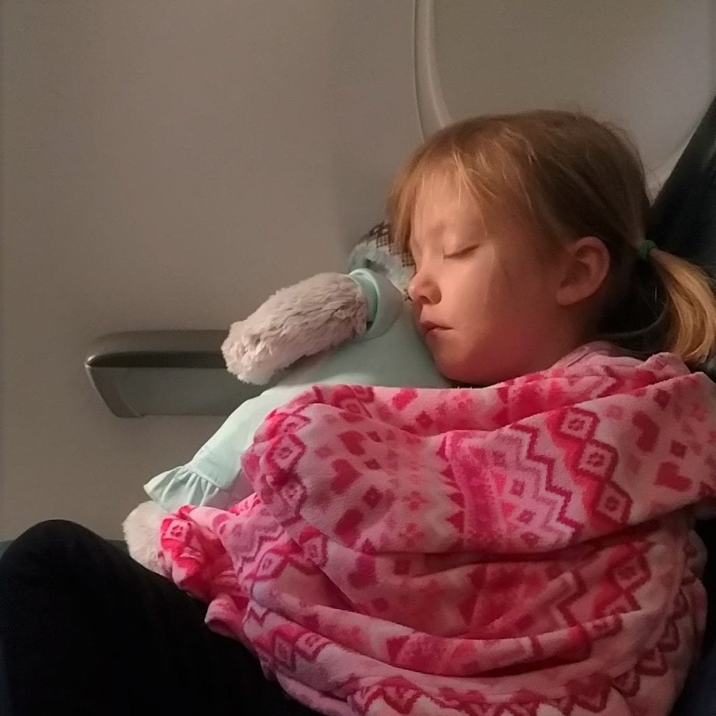 A little girl holding a baby