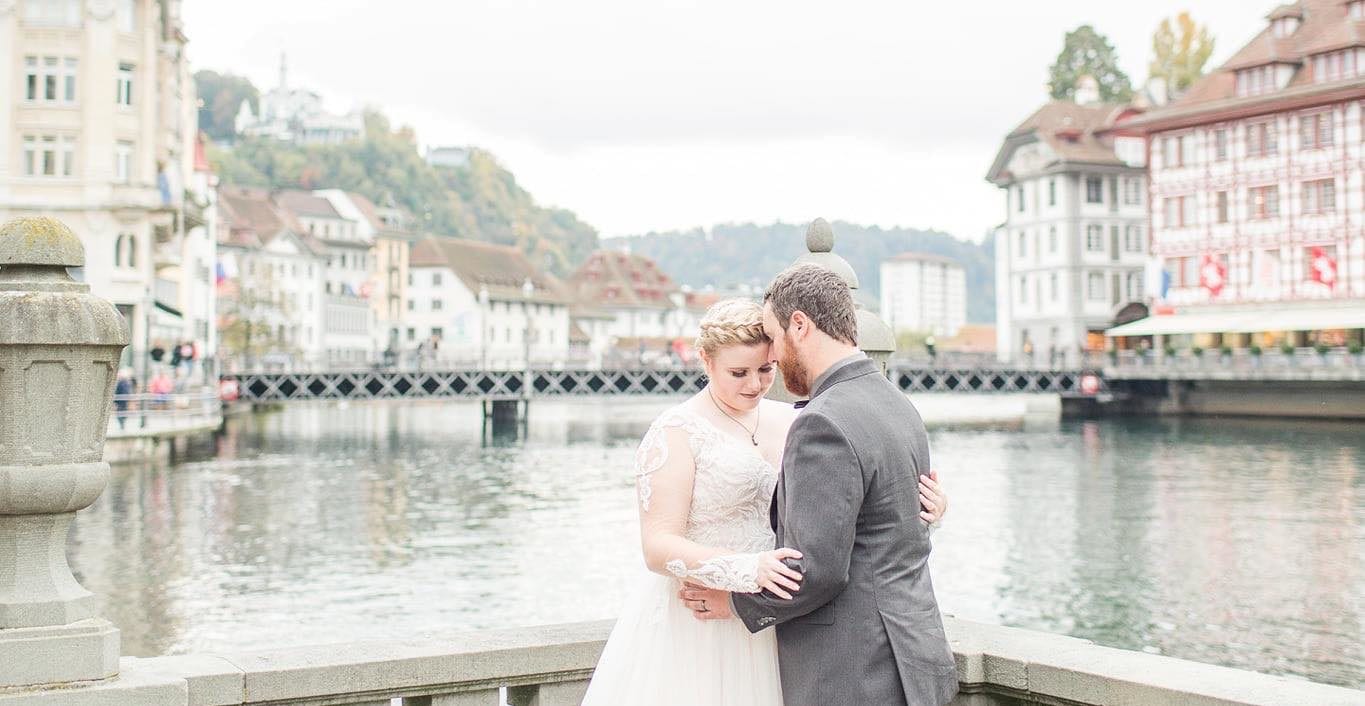 A man and woman standing in front of water