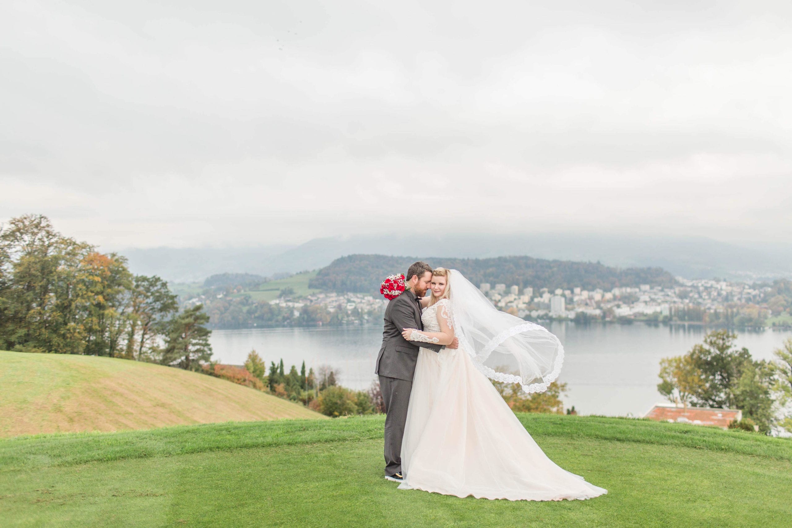 A couple that is standing in the grass