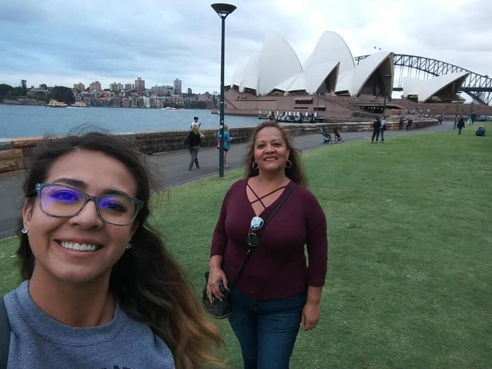 A woman standing in front of Josefina López et al. posing for the camera
