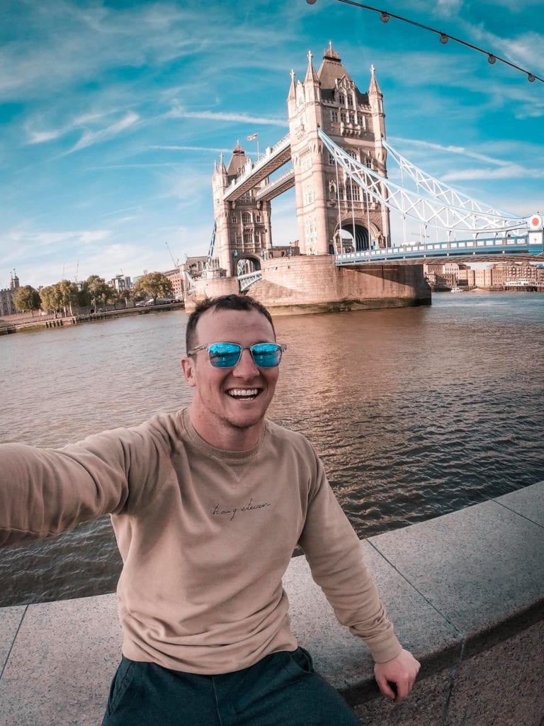 A man standing next to a body of water