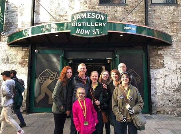 A group of people standing in front of a building