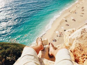 a man standing on a cliff by the ocean