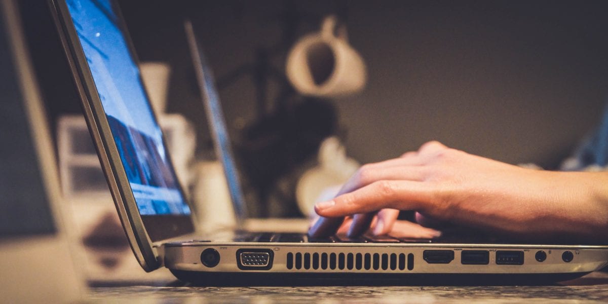 A close up of a person using a laptop