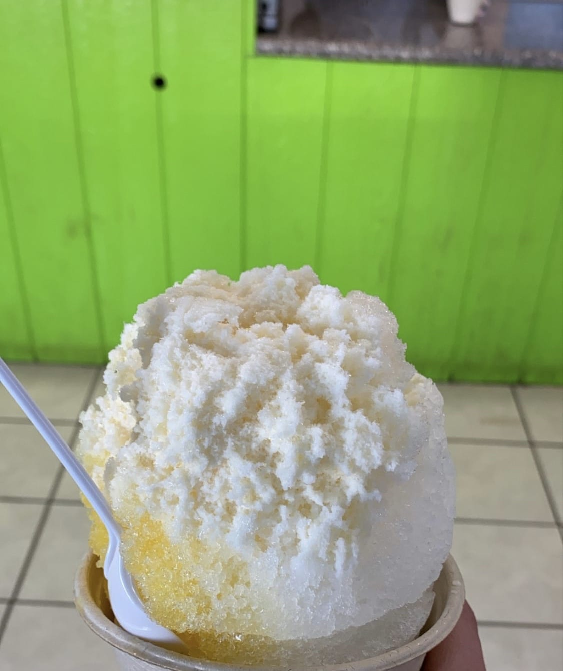 A large scoop of shave ice with yellow