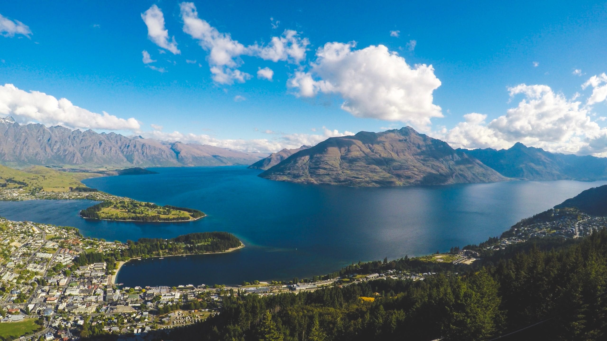 A body of water with a mountain in the background