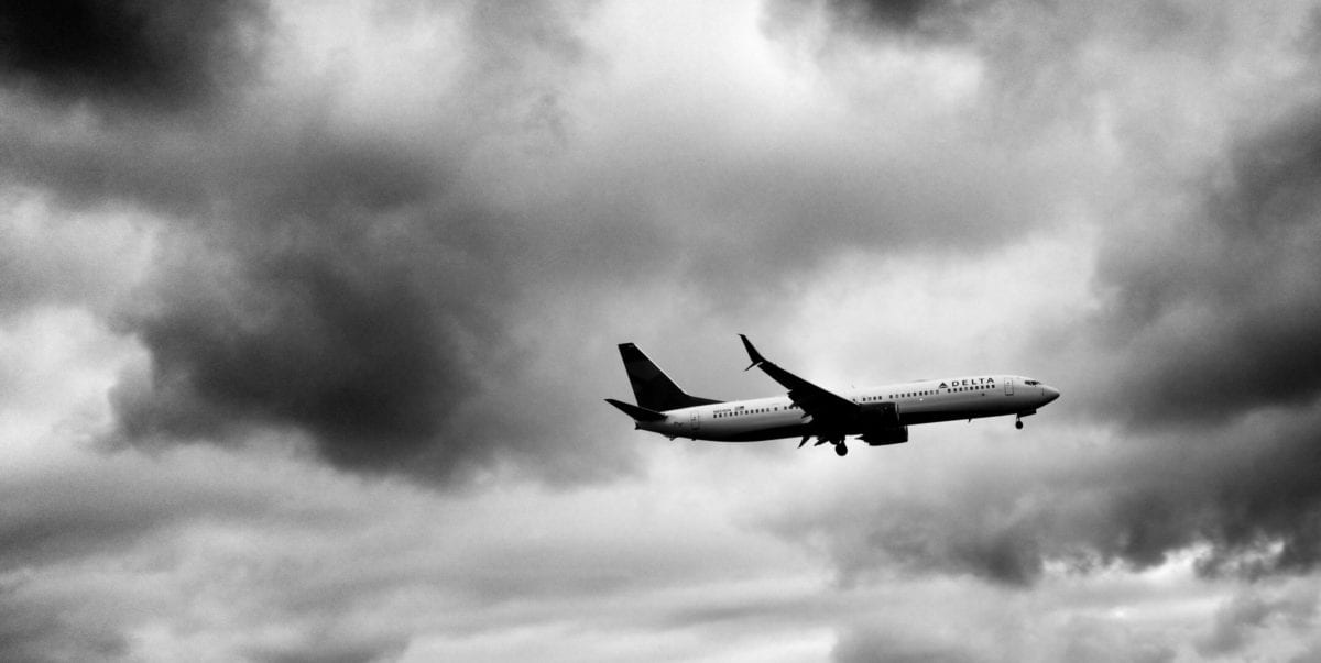 A large passenger jet flying through a cloudy sky