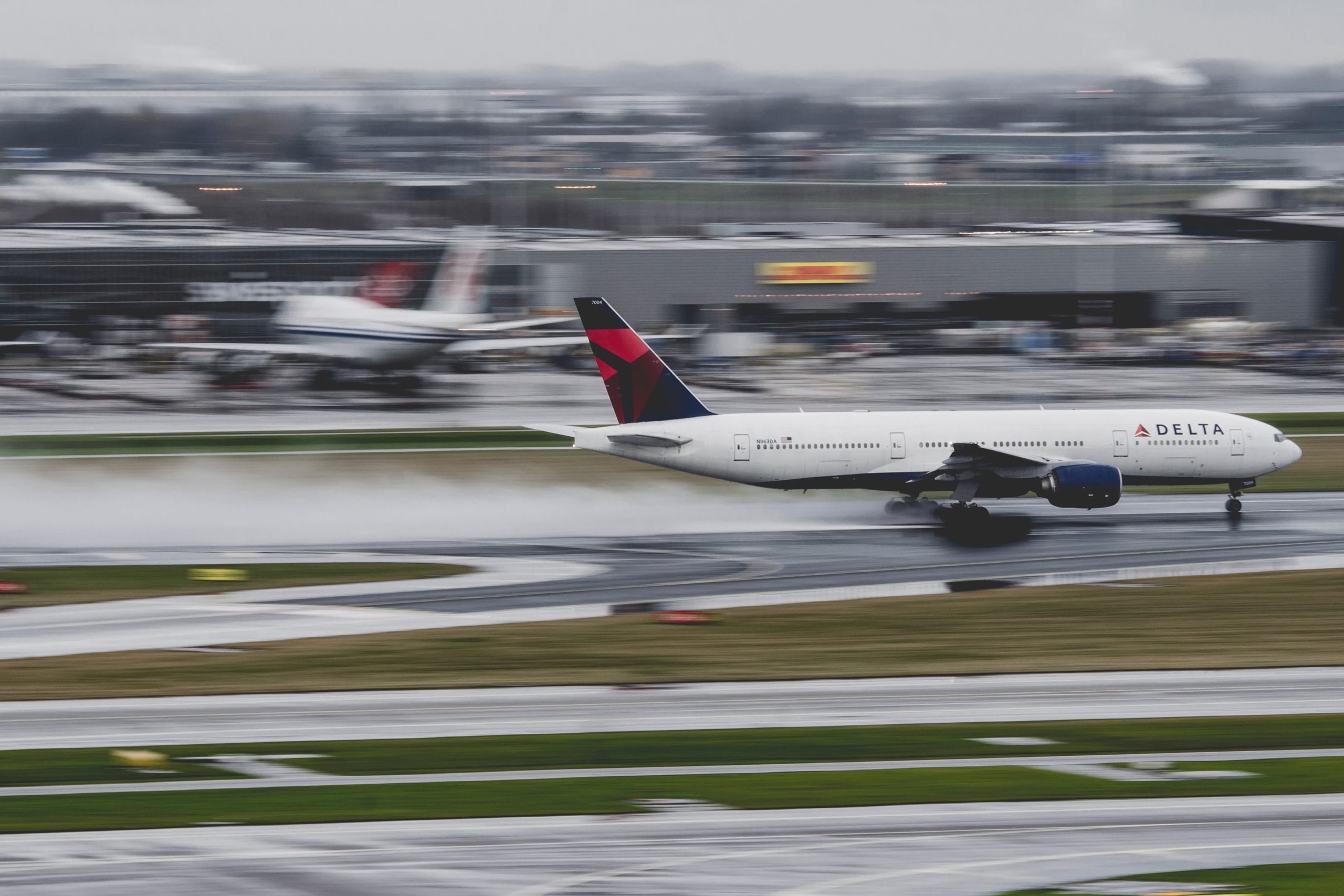A delta jet sitting on top of a runway