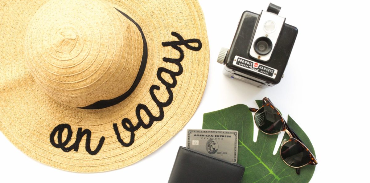 amex platinum card with a camera and a hat