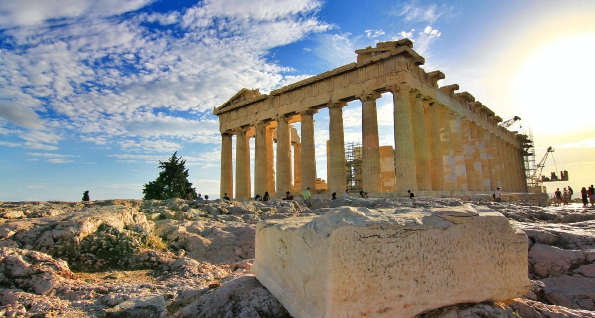 A stone building that has a rocky cliff