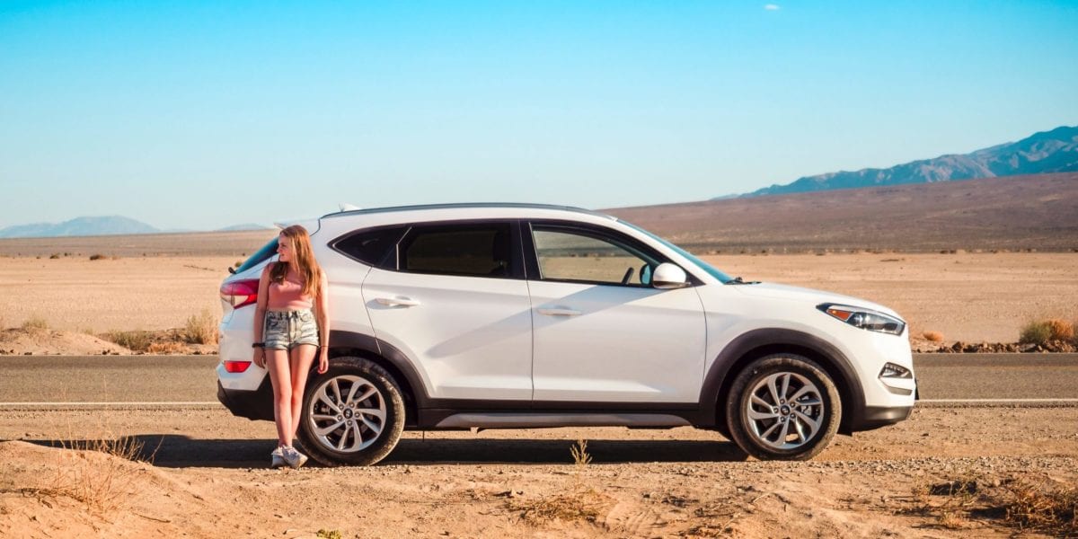 A car parked on the side of a dirt road