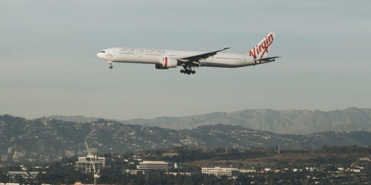 A large passenger jet flying over a city