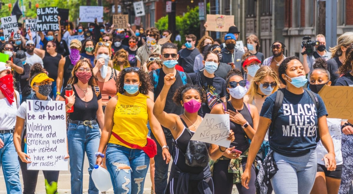 A group of people standing in front of a crowd posing for the camera
