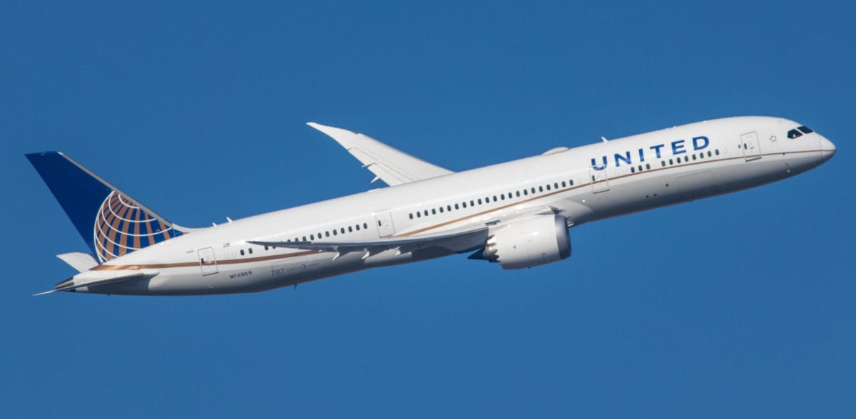 A large passenger jet flying through a blue sky