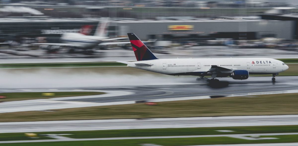 delta airplane taking off on a wet runway