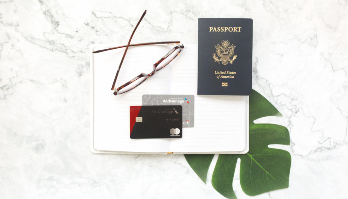 American Airlines credit cards with a passport and glasses