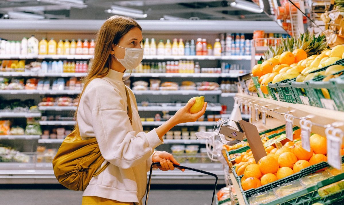 Masked woman grocery shopping
