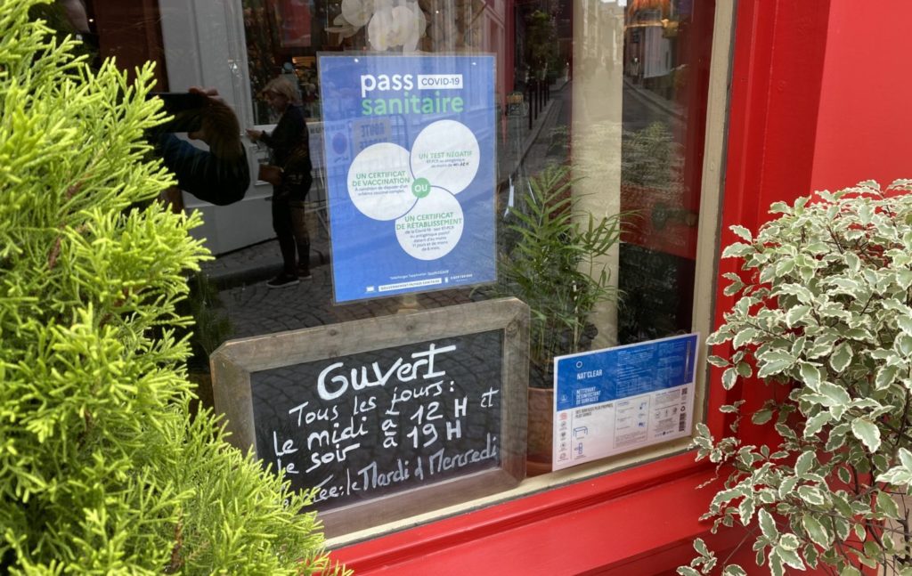 Health Pass sign in restaurant window