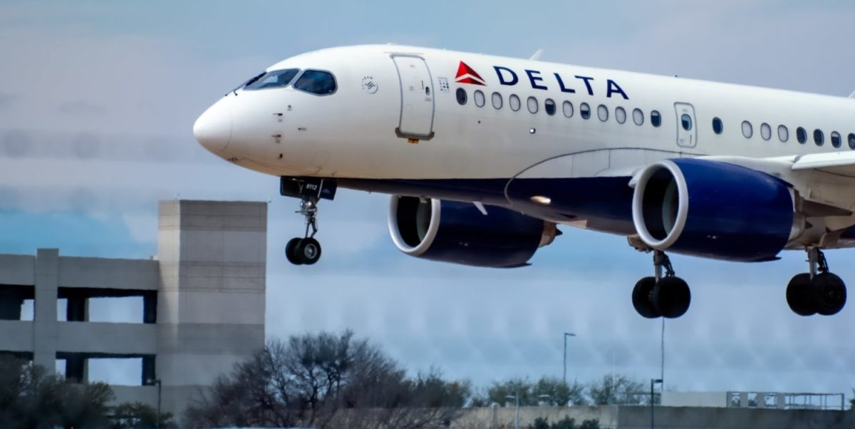 A large passenger jet flying through a blue sky