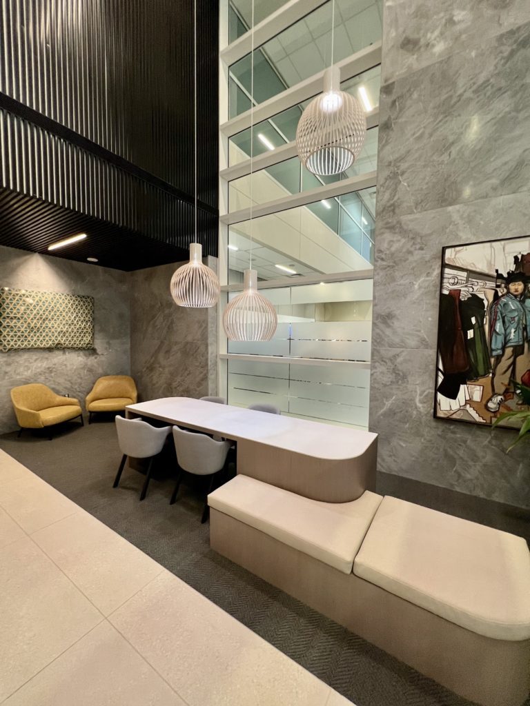 entryway with a table and elevator bank