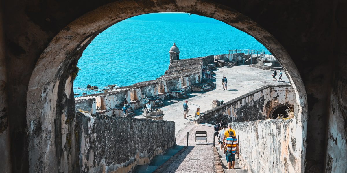 A tunnel with a bridge in the background