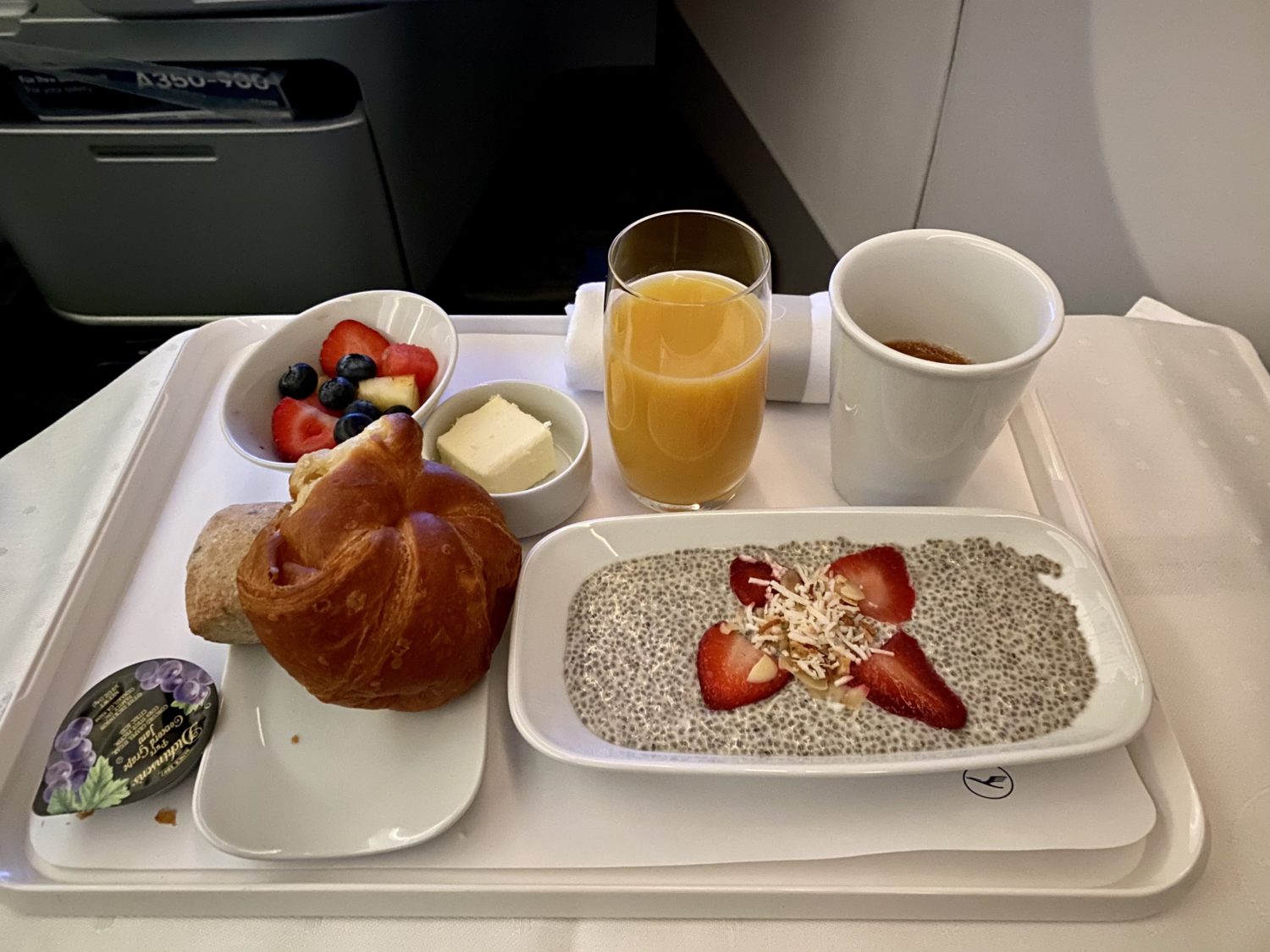 chia seed pudding with berries and a croissant